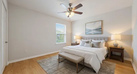 a bedroom with a bed and a chandelier