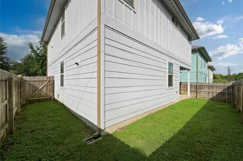 a view of backyard with wooden fence