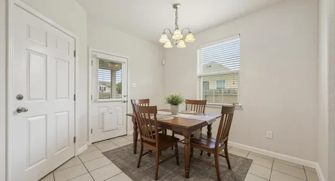 a view of a dining room with furniture and window