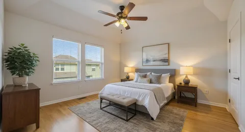 a bedroom with a bed and a chandelier
