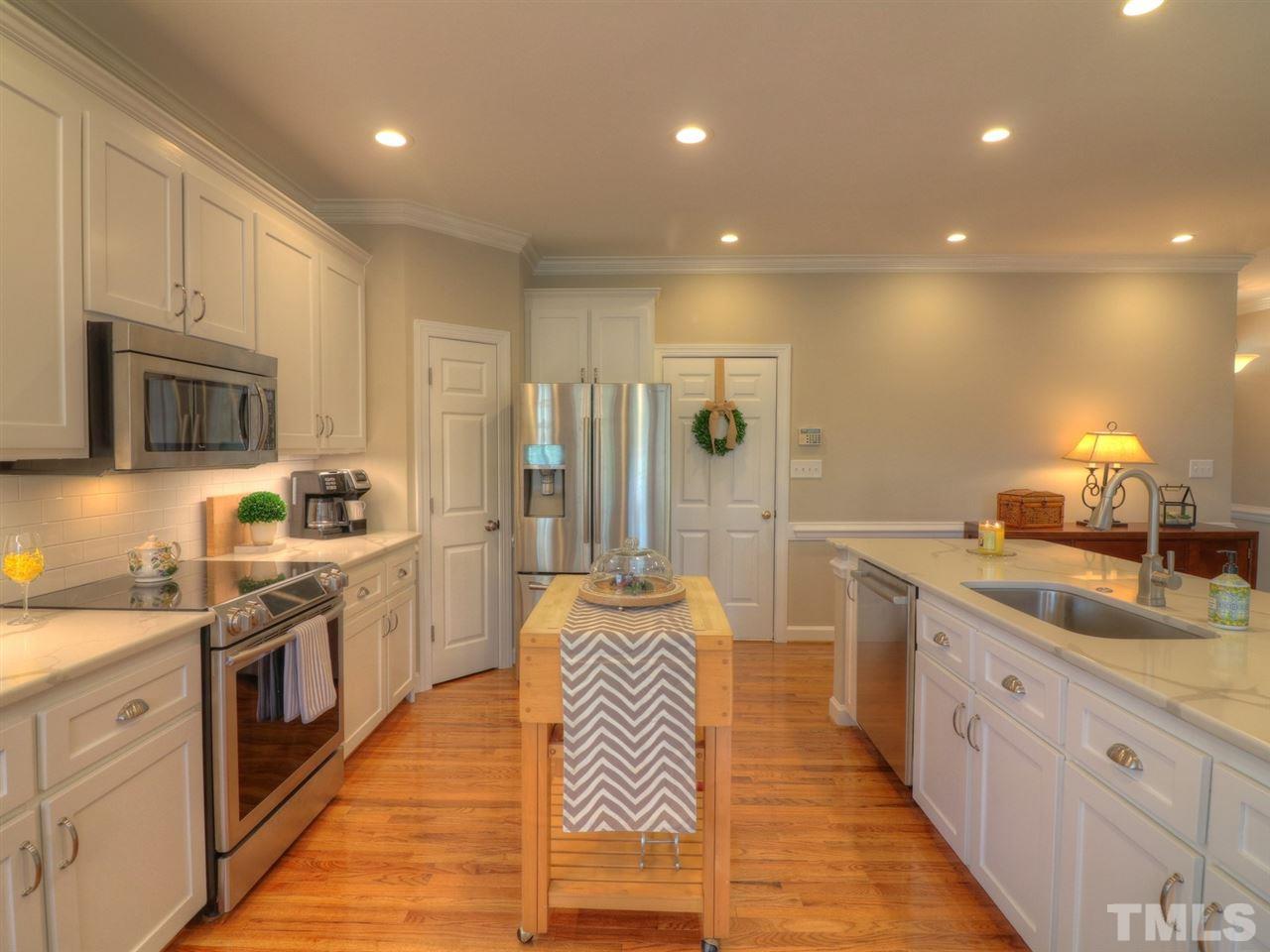 9304 Dawnshire Road Raleigh, NC 27615 - Photo 11 of 30 a large kitchen with stainless steel appliances granite countertop a sink and cabinets