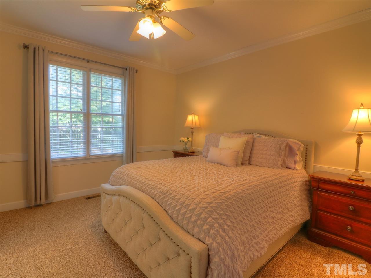9304 Dawnshire Road Raleigh, NC 27615 - Photo 13 of 30 a bed sitting in a bedroom next to a window