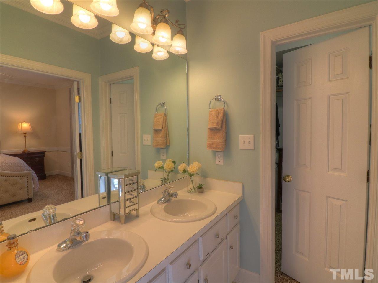 9304 Dawnshire Road Raleigh, NC 27615 - Photo 16 of 30 a bathroom with double vanity sinks and a mirror