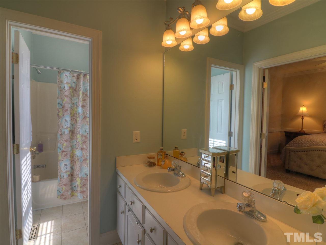 9304 Dawnshire Road Raleigh, NC 27615 - Photo 17 of 30 a bathroom with double vanity sink and a mirror