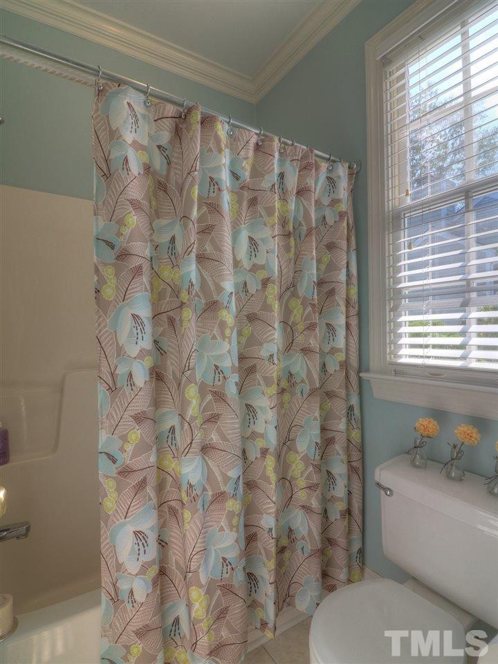 9304 Dawnshire Road Raleigh, NC 27615 - Photo 18 of 30 a bathroom with a toilet and a shower curtain