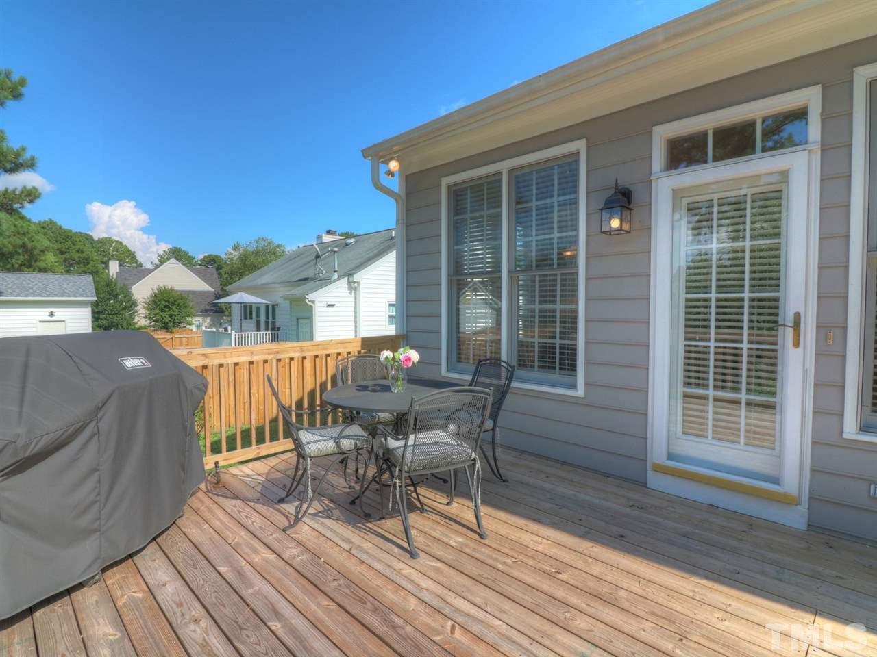 9304 Dawnshire Road Raleigh, NC 27615 - Photo 24 of 30 a view of a deck with table and chairs with wooden floor and fence