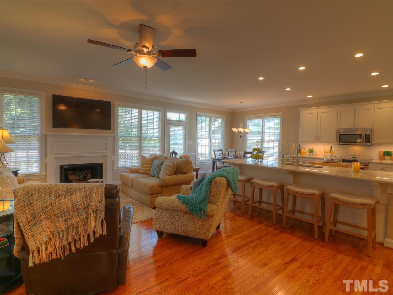 9304 Dawnshire Road Raleigh, NC 27615 - Photo 4 of 30 a living room with furniture a fireplace and a flat screen tv