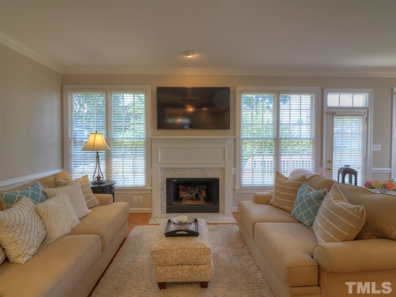 9304 Dawnshire Road Raleigh, NC 27615 - Photo 5 of 30 a living room with furniture and a fireplace