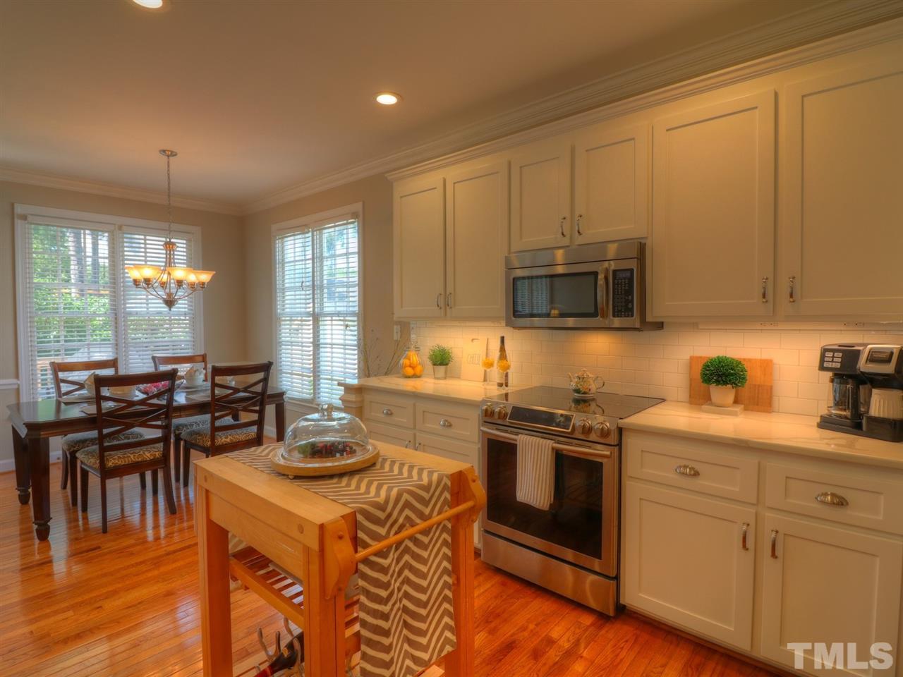 9304 Dawnshire Road Raleigh, NC 27615 - Photo 9 of 30 a kitchen with a stove a sink and a microwave