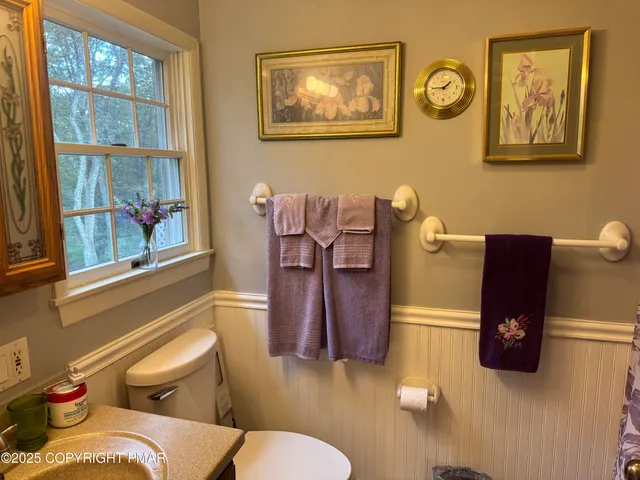 a living room with furniture and wall paintings