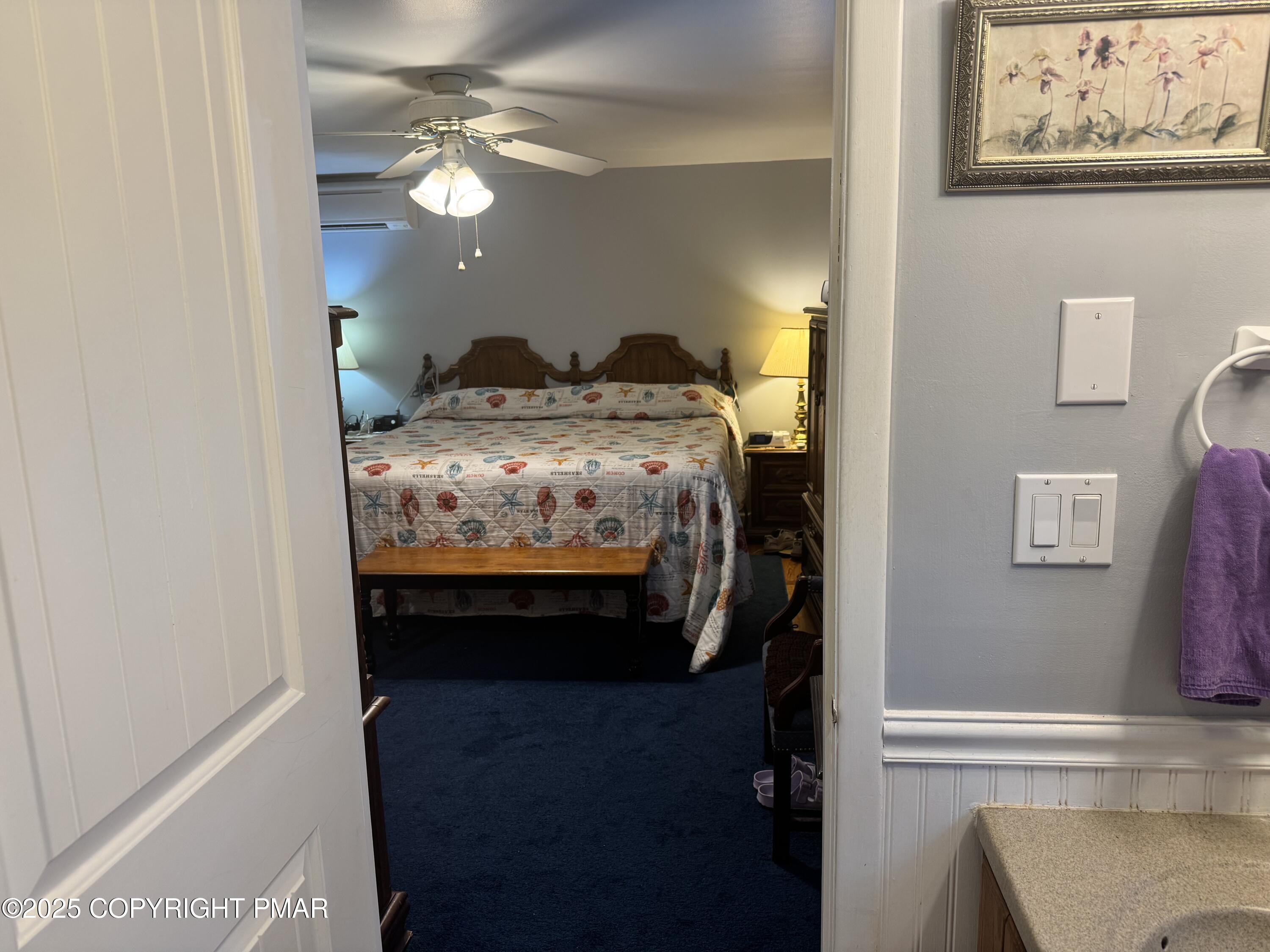 692 Watercrest Avenue Effort, PA 18330 - Photo 17 of 40 a bedroom with a bed and a chandelier