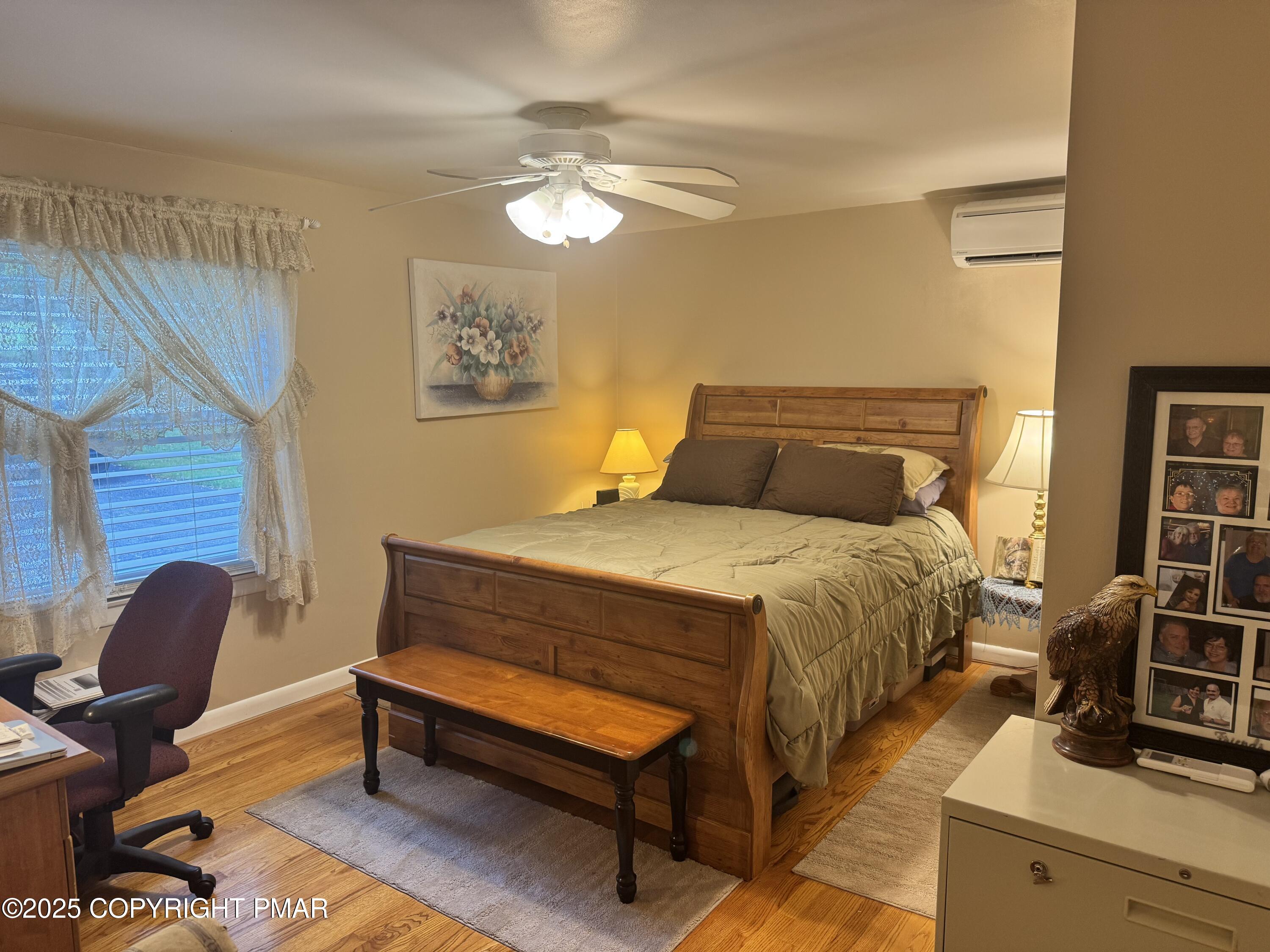 692 Watercrest Avenue Effort, PA 18330 - Photo 18 of 40 a bedroom with a bed and wooden floor