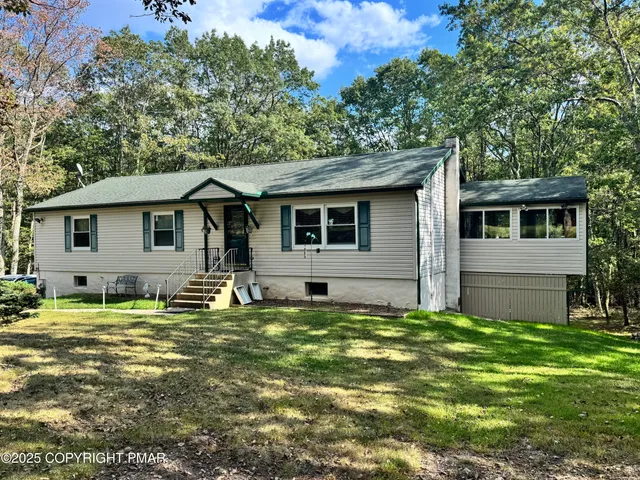 a backyard of a house with yard and outdoor seating