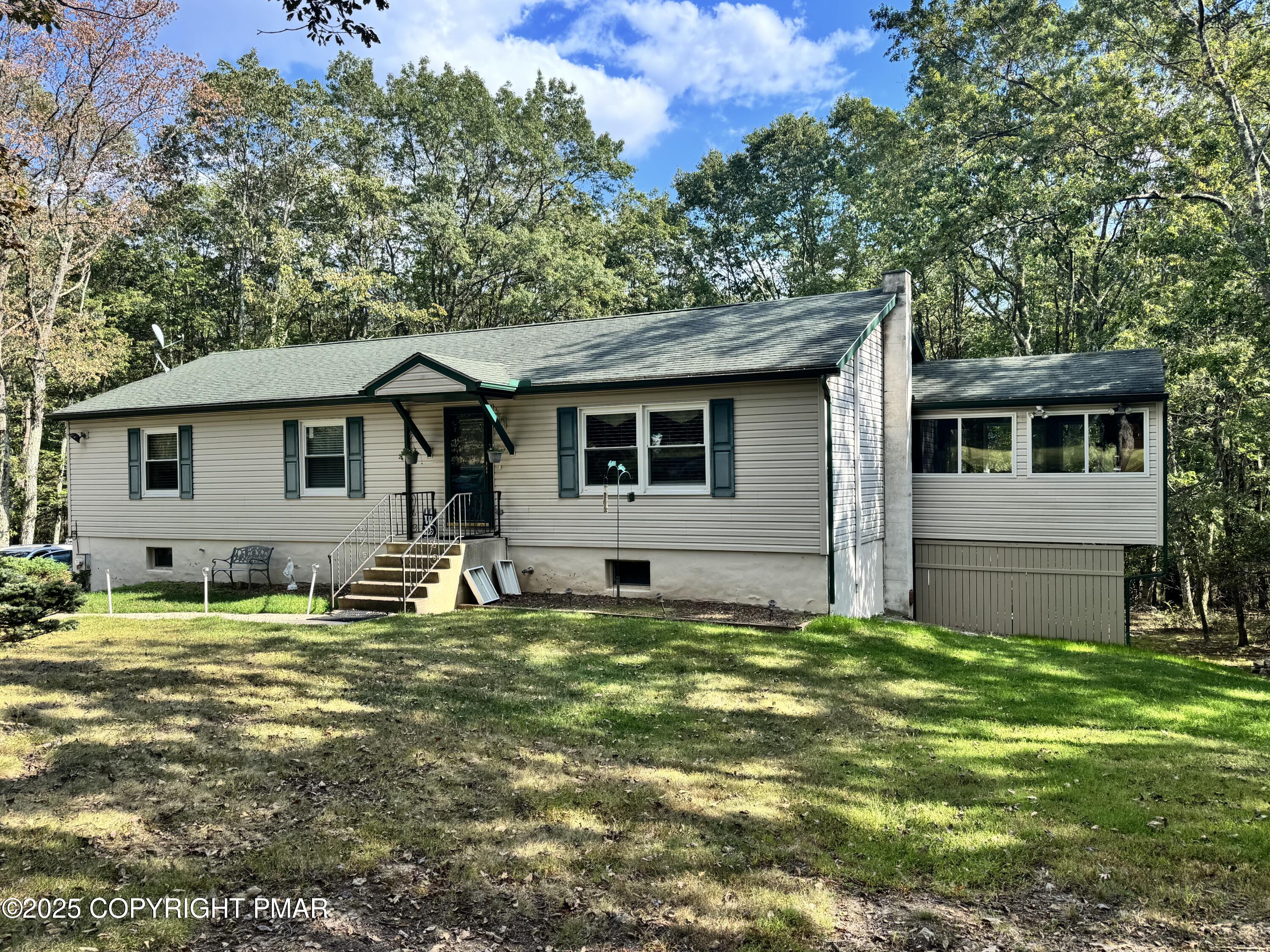 692 Watercrest Avenue Effort, PA 18330 - Photo 2 of 40 a backyard of a house with yard and outdoor seating