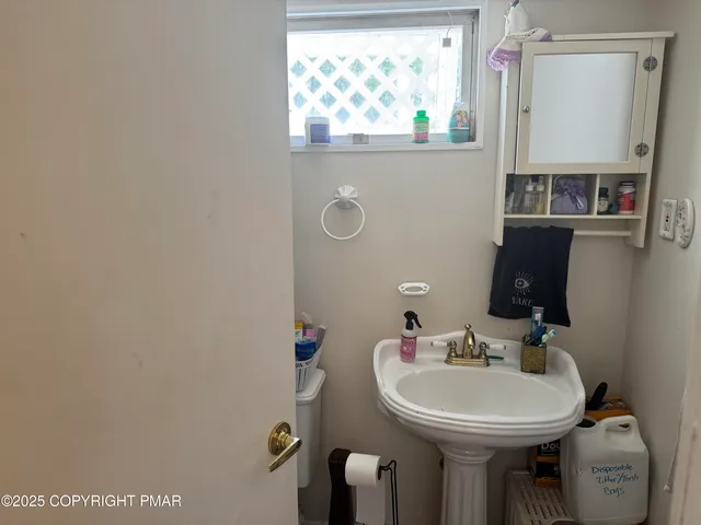 a bathroom with a sink mirror and toilet