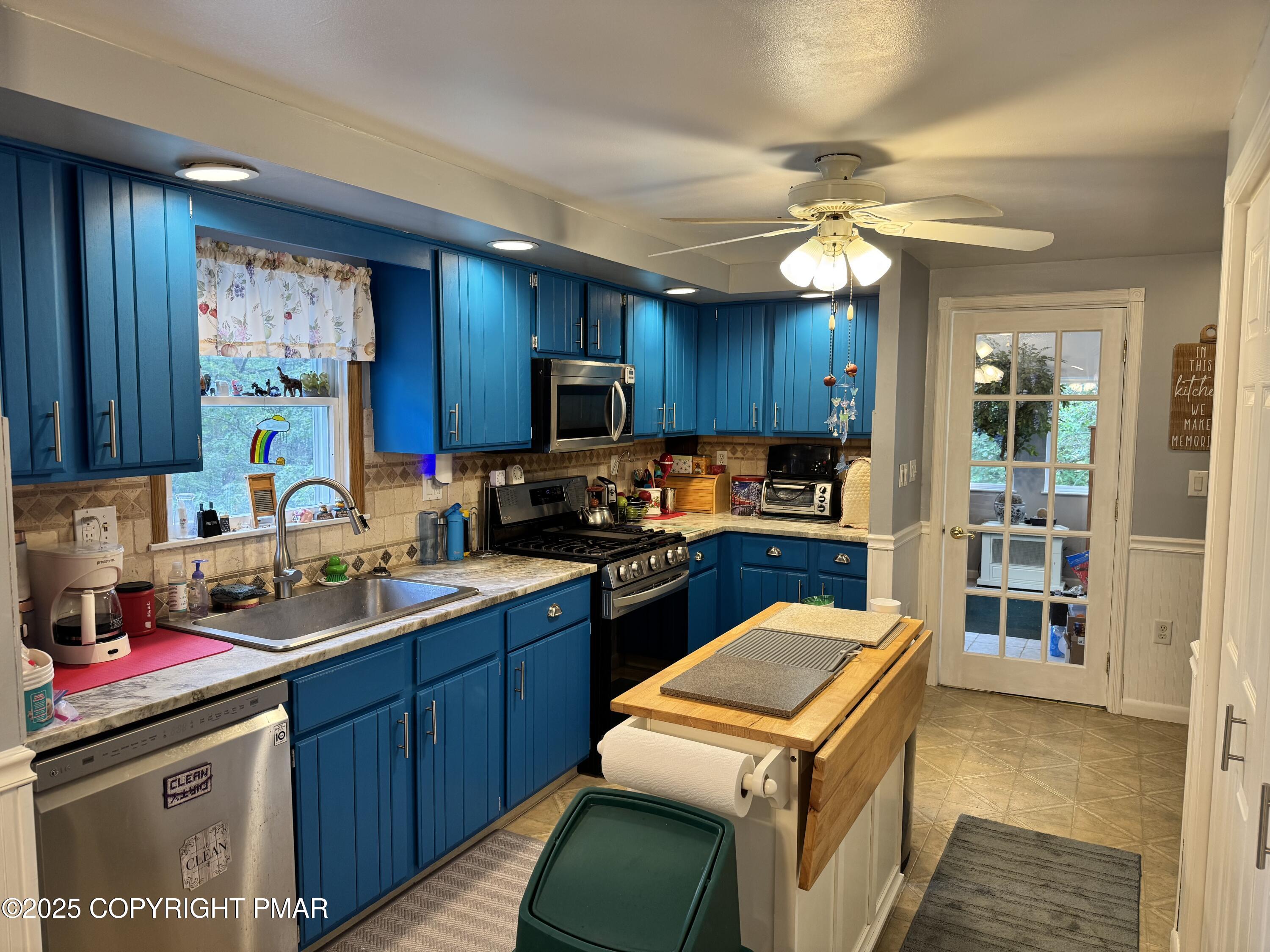 692 Watercrest Avenue Effort, PA 18330 - Photo 6 of 40 a kitchen with stainless steel appliances granite countertop a sink a stove top oven a counter space and cabinets