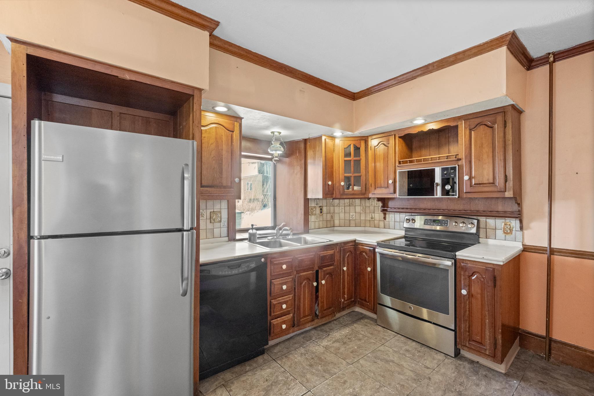 458 Renfrew Avenue Ambler, PA 19002 - Photo 18 of 31 a kitchen with stainless steel appliances granite countertop a refrigerator a sink and a stove
