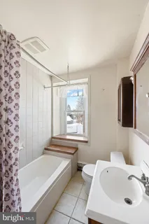 a bathroom with a bathtub and a sink