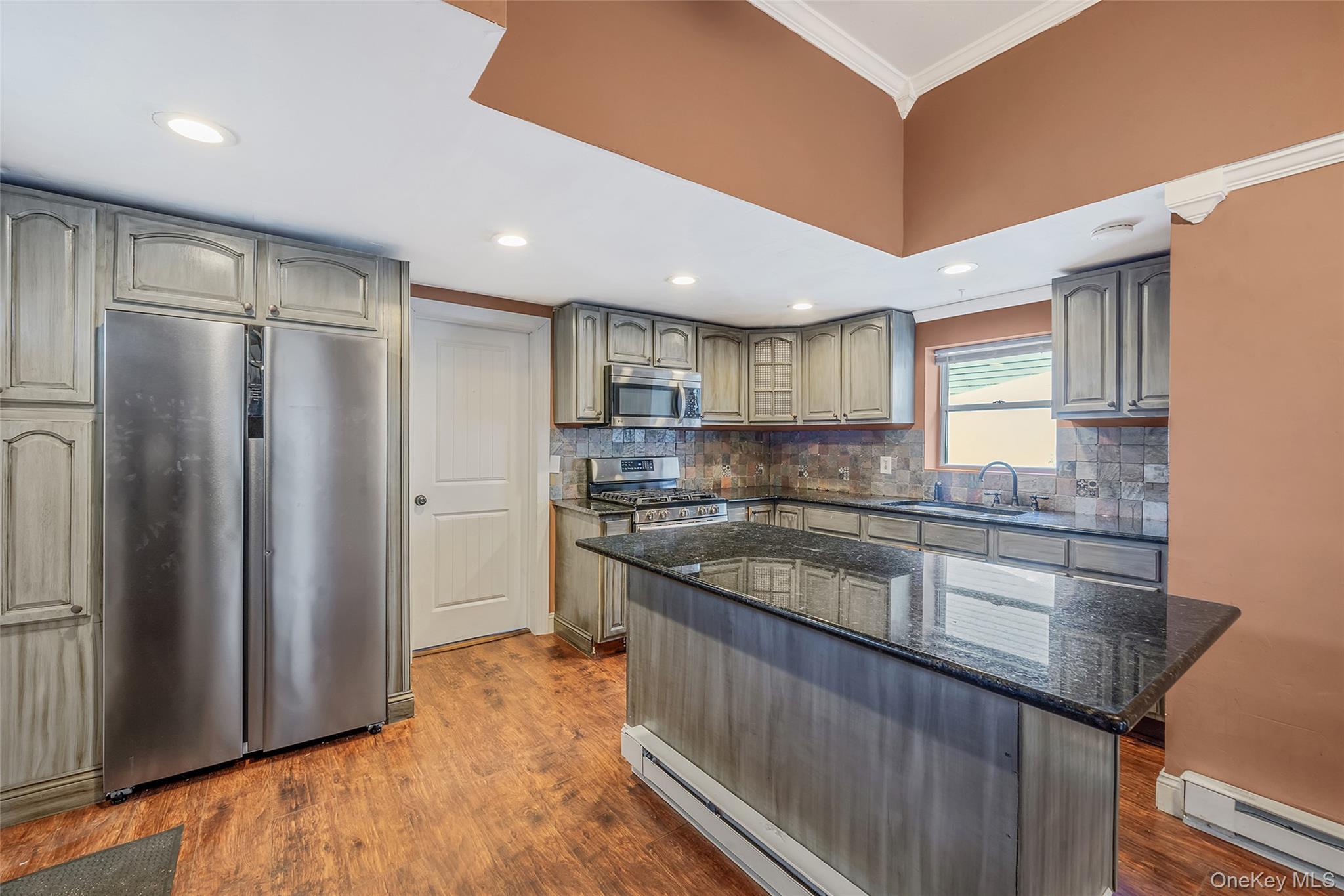 93 Maple Road Kings Park, NY 11754 - Photo 13 of 24 a kitchen with stainless steel appliances granite countertop a refrigerator and a sink