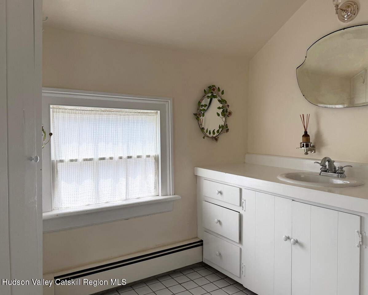 84 Sickler Road Lake Hill, NY 12448 - Photo 20 of 24 a bathroom with a sink and a mirror