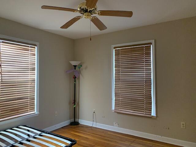1631 Bacom Point Road Pahokee, FL 33476 - Photo 14 of 19 a view of room with window and wooden floor