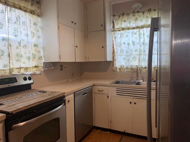 1631 Bacom Point Road Pahokee, FL 33476 - Photo 3 of 19 a kitchen with a stove and a white cabinet