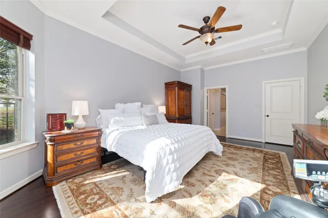 a bedroom with a bed and a ceiling fan