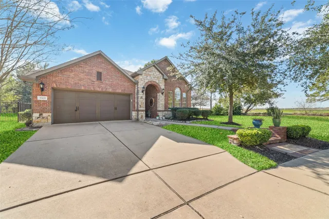 a front view of house with yard and green space