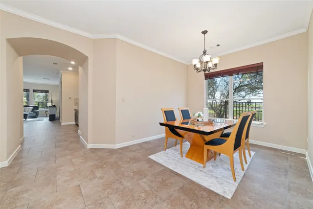 a view of a dining room with furniture and chandelier