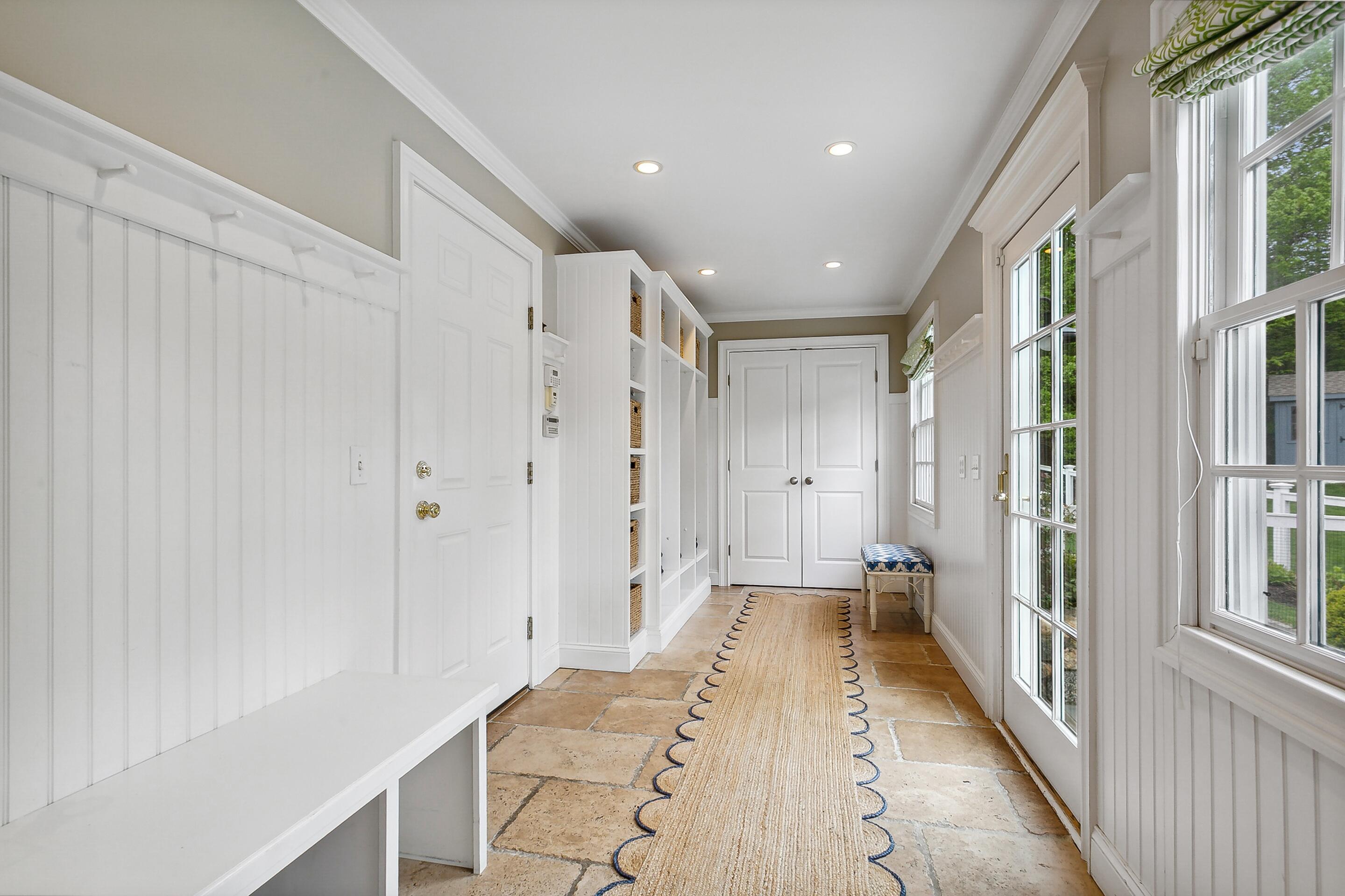 64 Summit Ridge Road New Canaan, CT 06840 - Photo 15 of 39 a view of a hallway with wooden floor and a bathroom