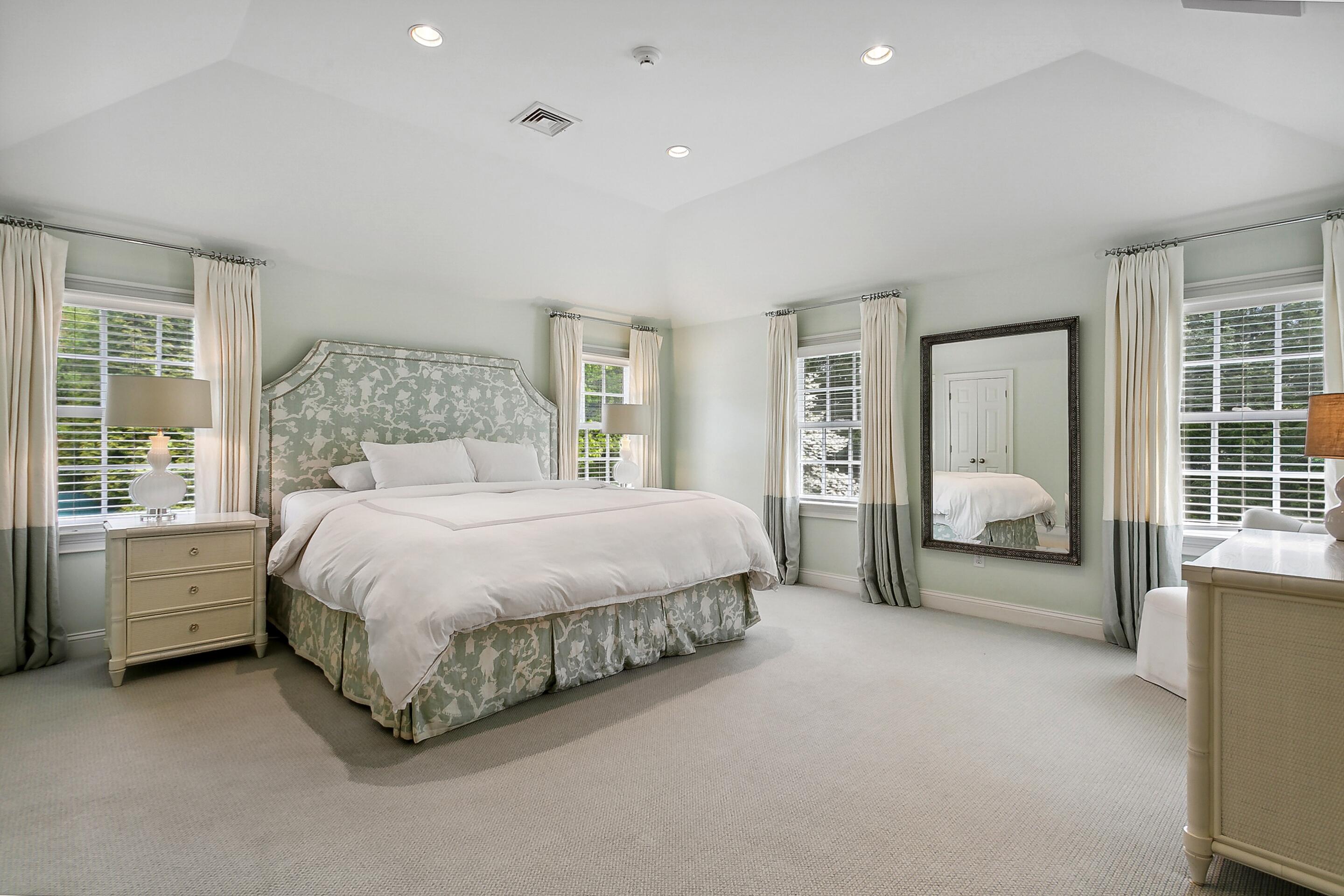 64 Summit Ridge Road New Canaan, CT 06840 - Photo 17 of 39 a spacious bedroom with a bed and a large window
