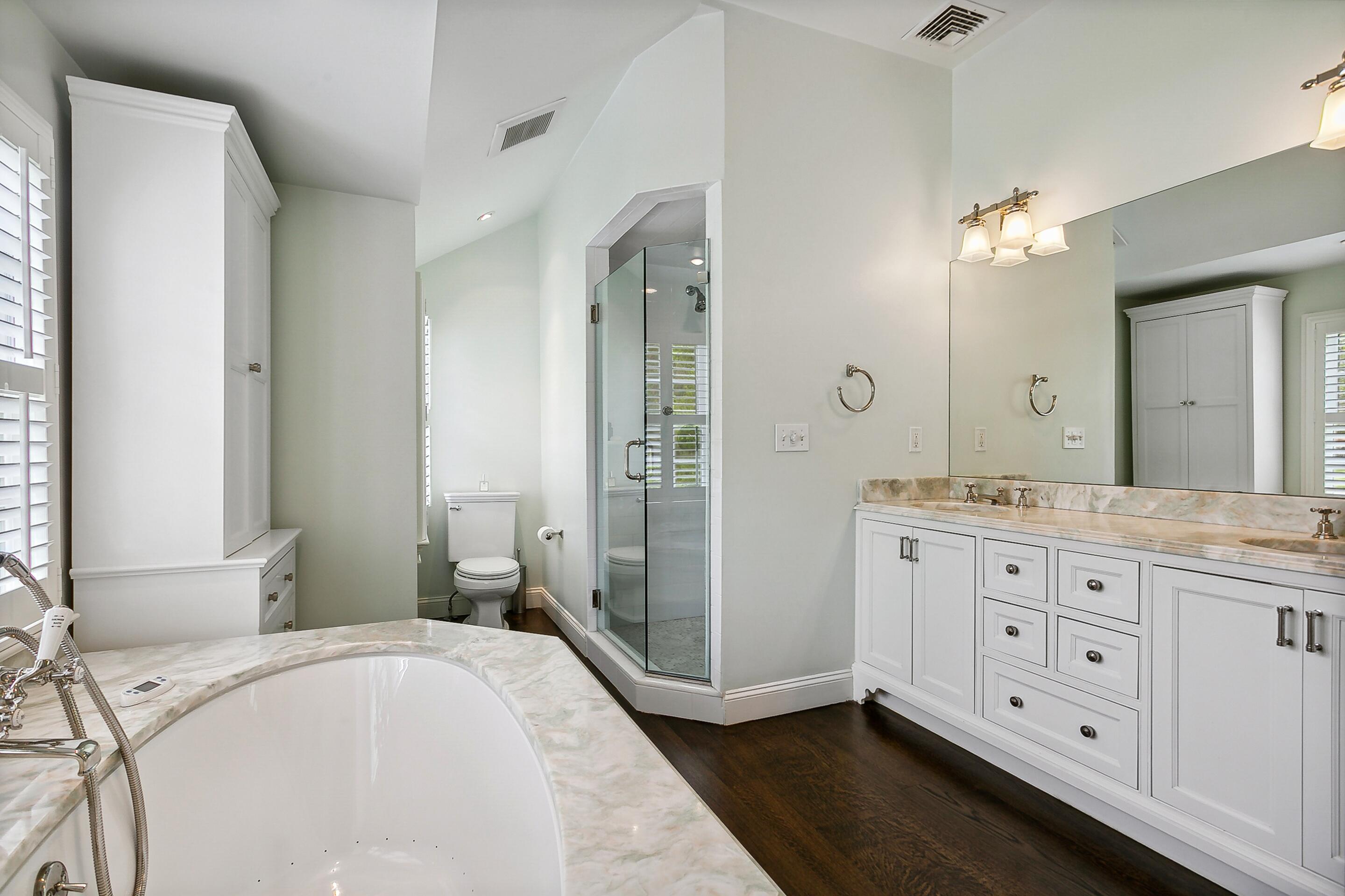 64 Summit Ridge Road New Canaan, CT 06840 - Photo 18 of 39 a spacious bathroom with a granite countertop sink mirror and a