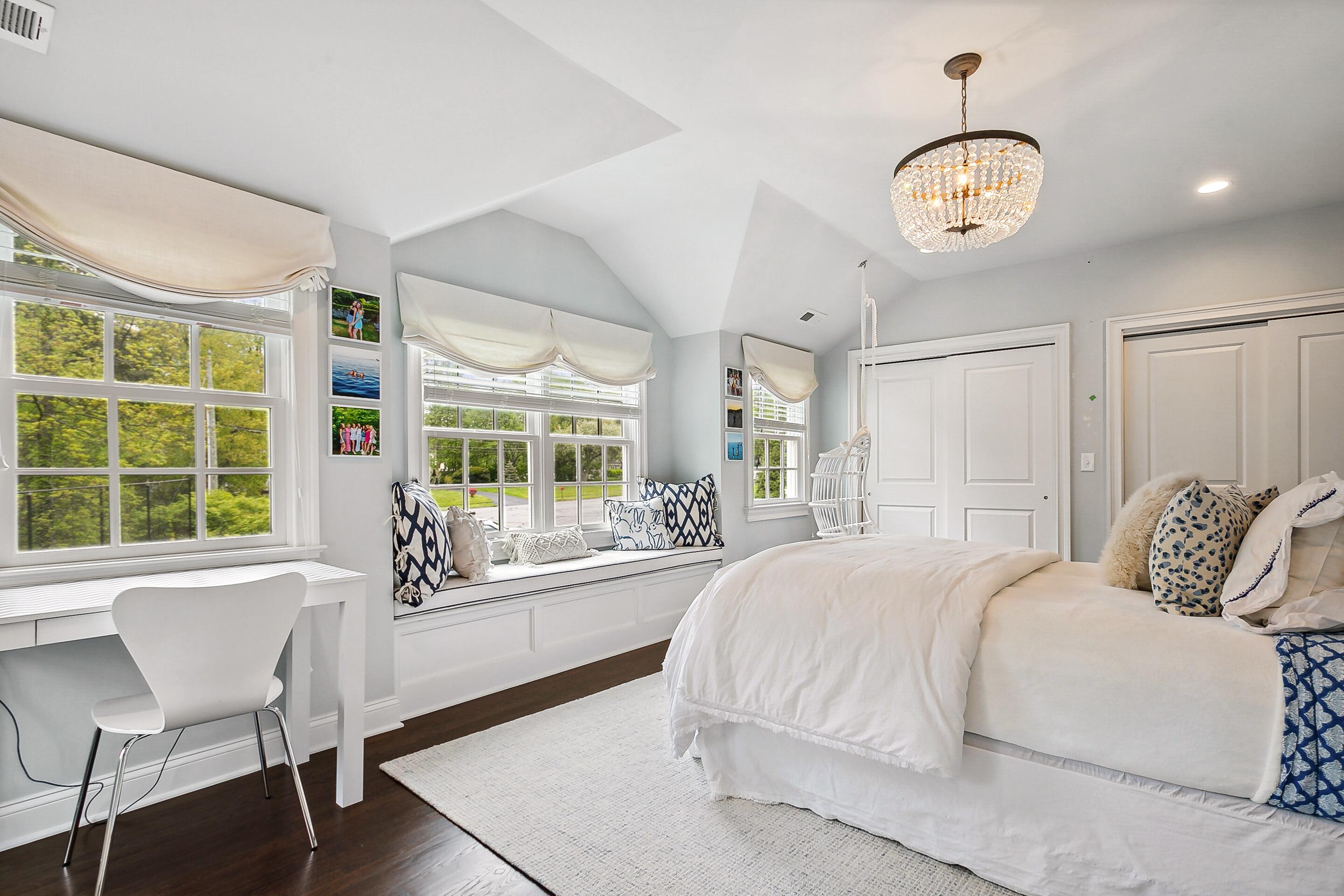 64 Summit Ridge Road New Canaan, CT 06840 - Photo 20 of 39 a bedroom with a large bed and a large window