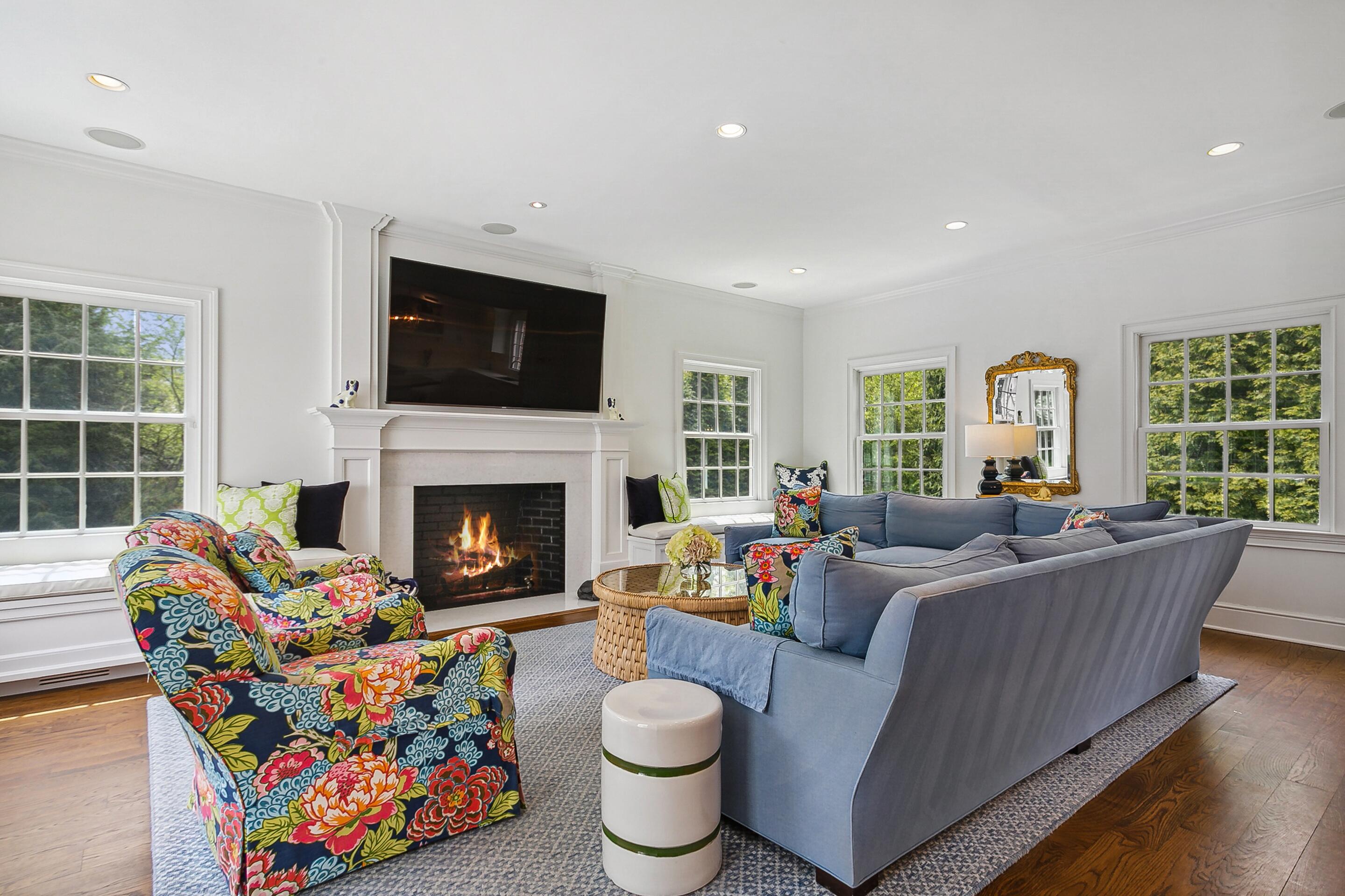 64 Summit Ridge Road New Canaan, CT 06840 - Photo 2 of 39 a living room with furniture a flat screen tv and a fireplace