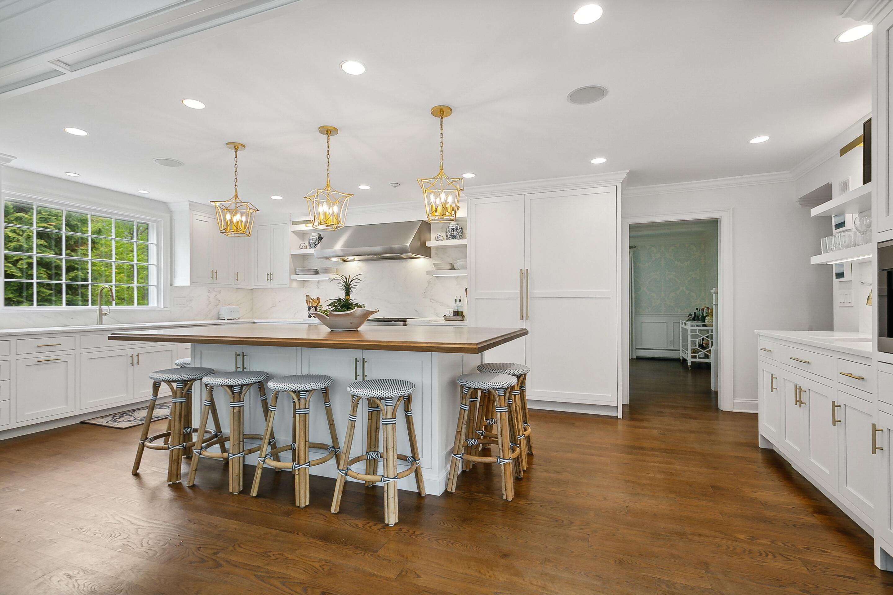 64 Summit Ridge Road New Canaan, CT 06840 - Photo 4 of 39 a kitchen with stainless steel appliances kitchen island granite countertop a table chairs in it and wooden floors