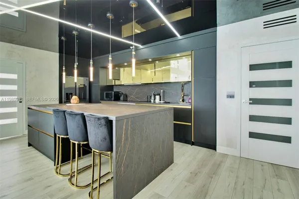 a kitchen with kitchen island a stove a sink and a refrigerator