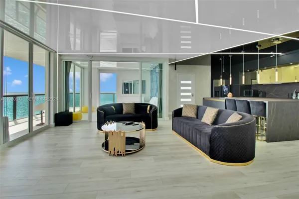 a living room with furniture and a chandelier