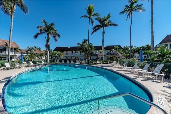 a view of swimming pool with a table and chairs