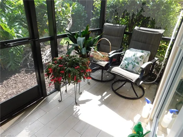 a view of a chairs and table in the balcony