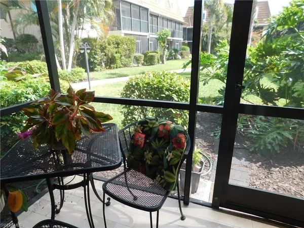 a view of a couple of trees and flowers in the patio