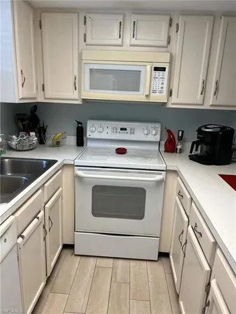a utility room with stainless steel appliances granite countertop a washer and dryer