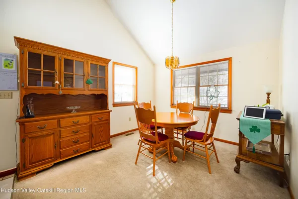 a dining room with furniture and window