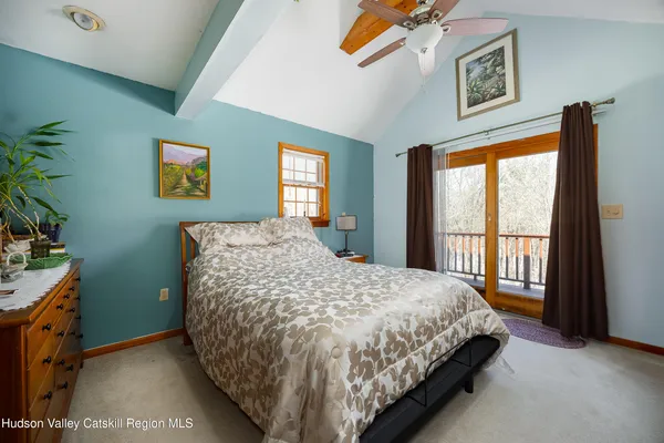 a bed sitting in a bedroom next to a window