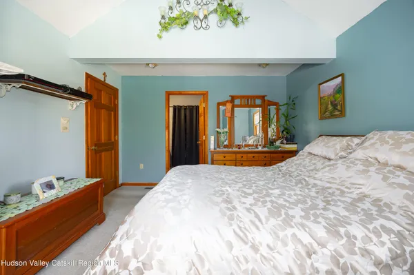 a bedroom with a bed and a dresser in it