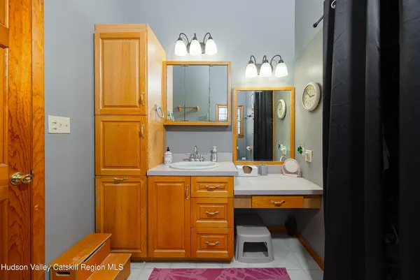 a bathroom with a sink vanity and a mirror