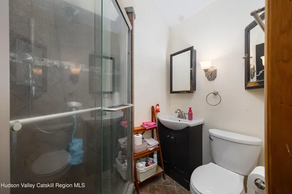 a white toilet sitting next to a bathroom sink