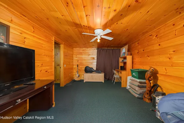a bedroom with furniture and flat screen tv