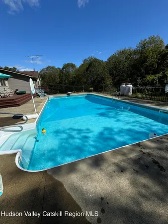 a view of a swimming pool with a yard