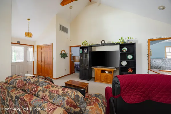 a bedroom with a bed and a flat tv screen
