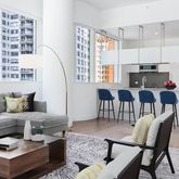 a living room with furniture a rug and a chandelier